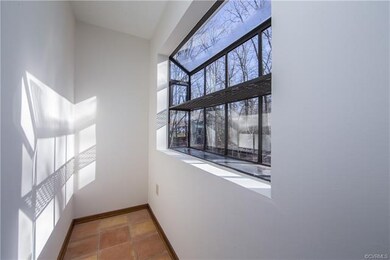 This small room off of the kitchen & utility rooms can be used for storage, growing & nurturing herbs & plants or a mini-office.