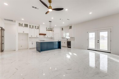 Kitchen with marble finish floor, custom range hoo