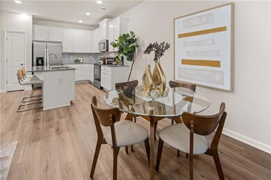 Dining space with light wood-style floors, recesse