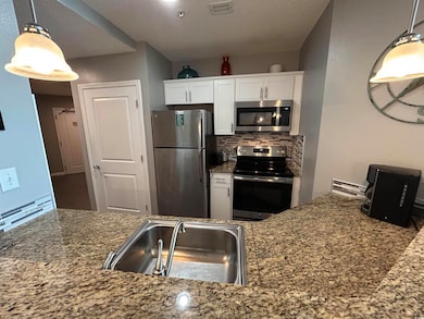 Kitchen featuring decorative backsplash, a sink, v