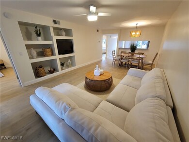 Living room featuring visible vents, built in shel