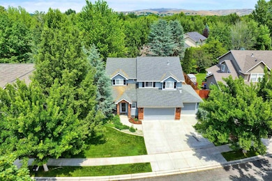 Aerial view of property and surrounding area with a forest