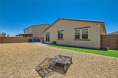 Back of property featuring a fire pit, a fenced ba