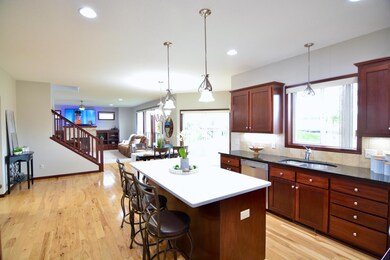 Another angle of the kitchen, Informal dining room and main floor family room.