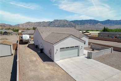 View of front of property featuring concrete driveway, a mountain view, stucco siding, and a garage