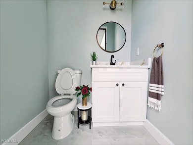Bathroom with vanity and marble finish floors