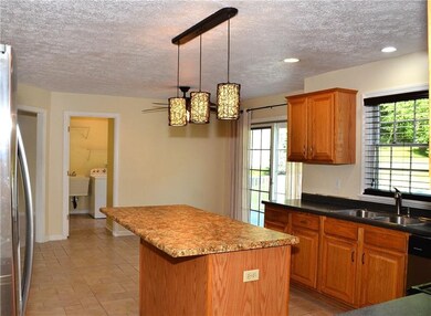 From the Kitchen, you can head outdoors through the rear glass slider door, or perhaps catch up on some quick laundry in the adjoining (but separated by a closing door) Laundry/Mud Room. The L/M room comes with washer & dryer, utility sink and has a 