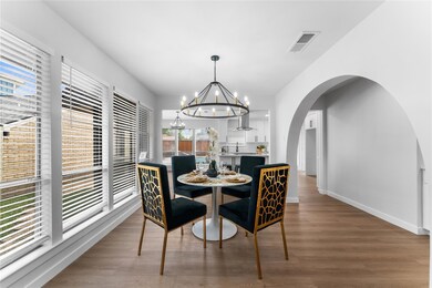 Living area with baseboards, wood finished floors,