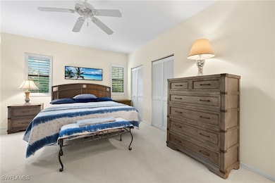 Bedroom with ceiling fan, baseboards, two closets,