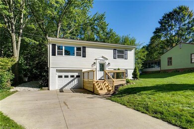 Bi-level home featuring garage and a front lawn