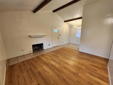 Unfurnished living room featuring wood finished f