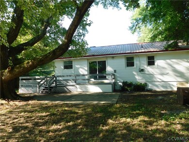 Back of property featuring a patio and a lawn