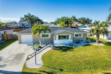 Single story home featuring a garage and a front y