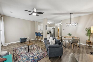 Living room featuring wood finished floors, ceiling fan, and baseboards