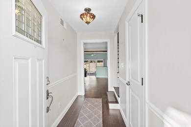 Corridor featuring dark wood-type flooring and a t