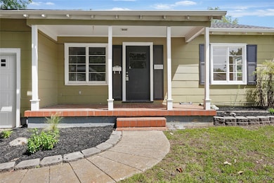View of exterior entry featuring covered porch