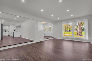 Unfurnished living room featuring dark wood-style floors and recessed lighting