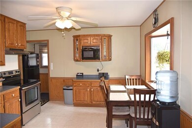 Large eat in kitchen with oak cabinets and large b