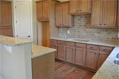 beautiful stone tile backsplash, cocoa glased maple cabinets