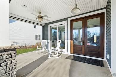 Property entrance featuring ceiling fan, french do