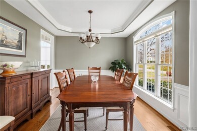 Dining room featuring a tray ceiling, ornamental m