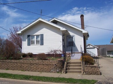 Front of home w/single car garage, paved private d