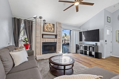 Living room with wood finished floors, a fireplac