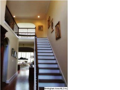 The two-story foyer is so spacious! Love the hardw