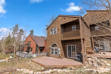 Rear view of house featuring a deck and a balcony