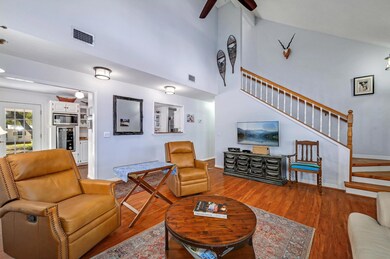 Living area with stairway, wood finished floors, 