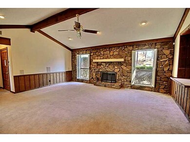 Vaulted Great Room with Wood Beams, Stone Wall & F
