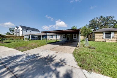 Covered carport with long driveway.