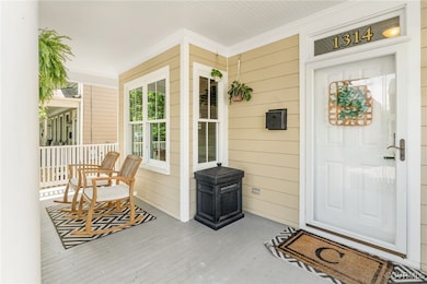 Doorway to property featuring covered porch