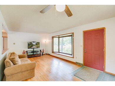 Main level living room with hardwood floors and ba