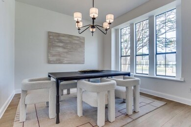 Dining room featuring wood-type flooring and a cha