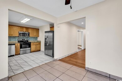 Kitchen featuring light tile patterned floors, sta