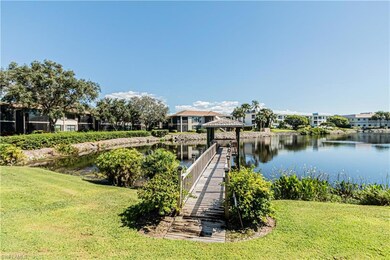 Dock featuring a gazebo, a water view, and a yard