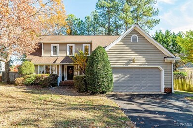 View of property with a garage and a front lawn