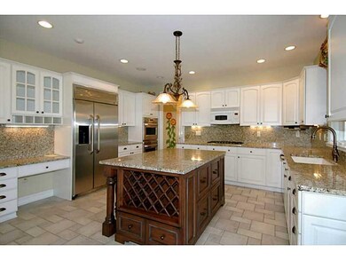 Kitchen. The wood-stained center island with wine 
