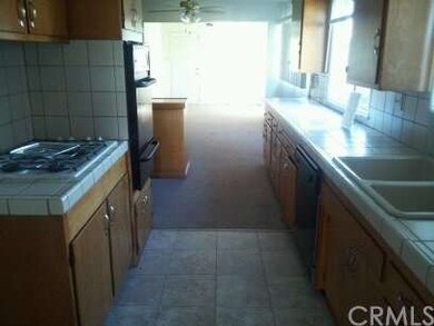 View of kitchen from garage entry into dining area