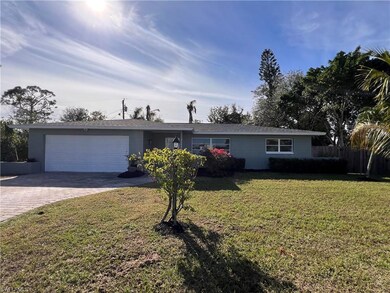 Ranch-style home with a garage and a front lawn