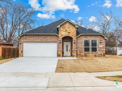 View of front of house with a garage, stone siding