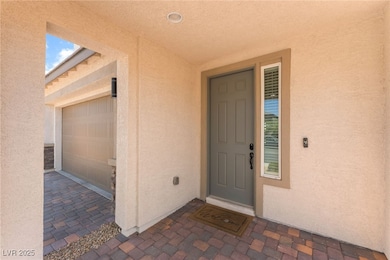 Entrance to property featuring stucco siding and a