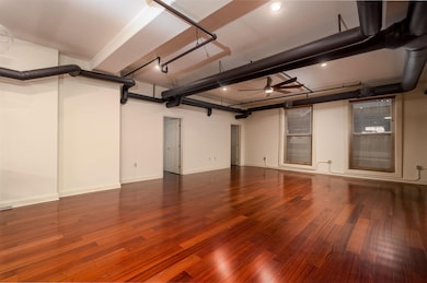 Garage with baseboards and a ceiling fan