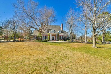 View of front facade with a chimney, a front lawn,