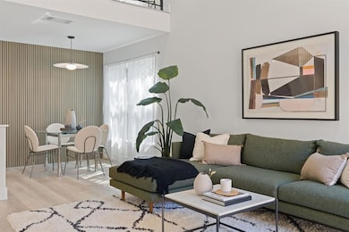 Living room featuring visible vents and wood fini