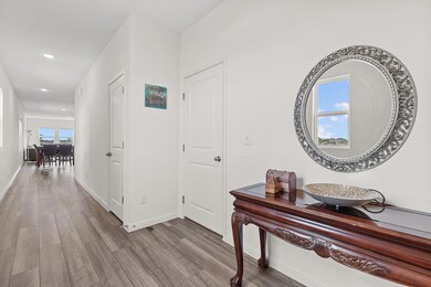 Hall with wood finished floors and recessed lighting