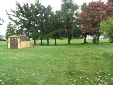 Level yard with a storage shed.