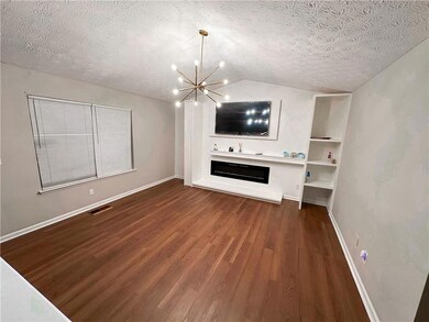 Unfurnished living room featuring an inviting chan