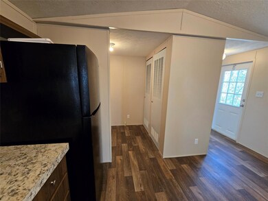 Kitchen featuring a textured ceiling, freestandin